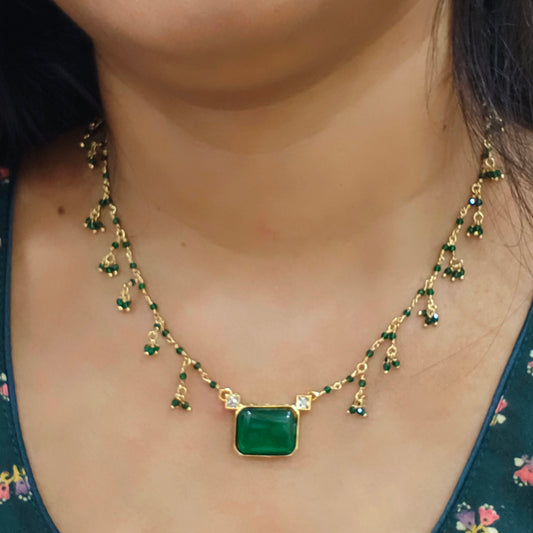 Green stone pendant with green beads.