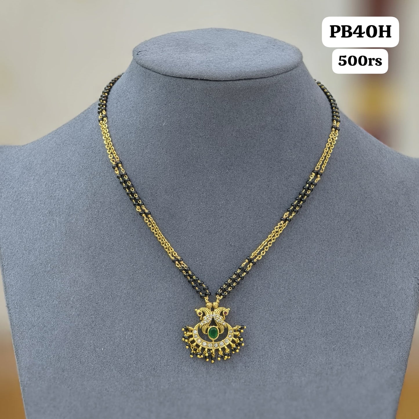 Peacock pendant with 2 lines of short black beads