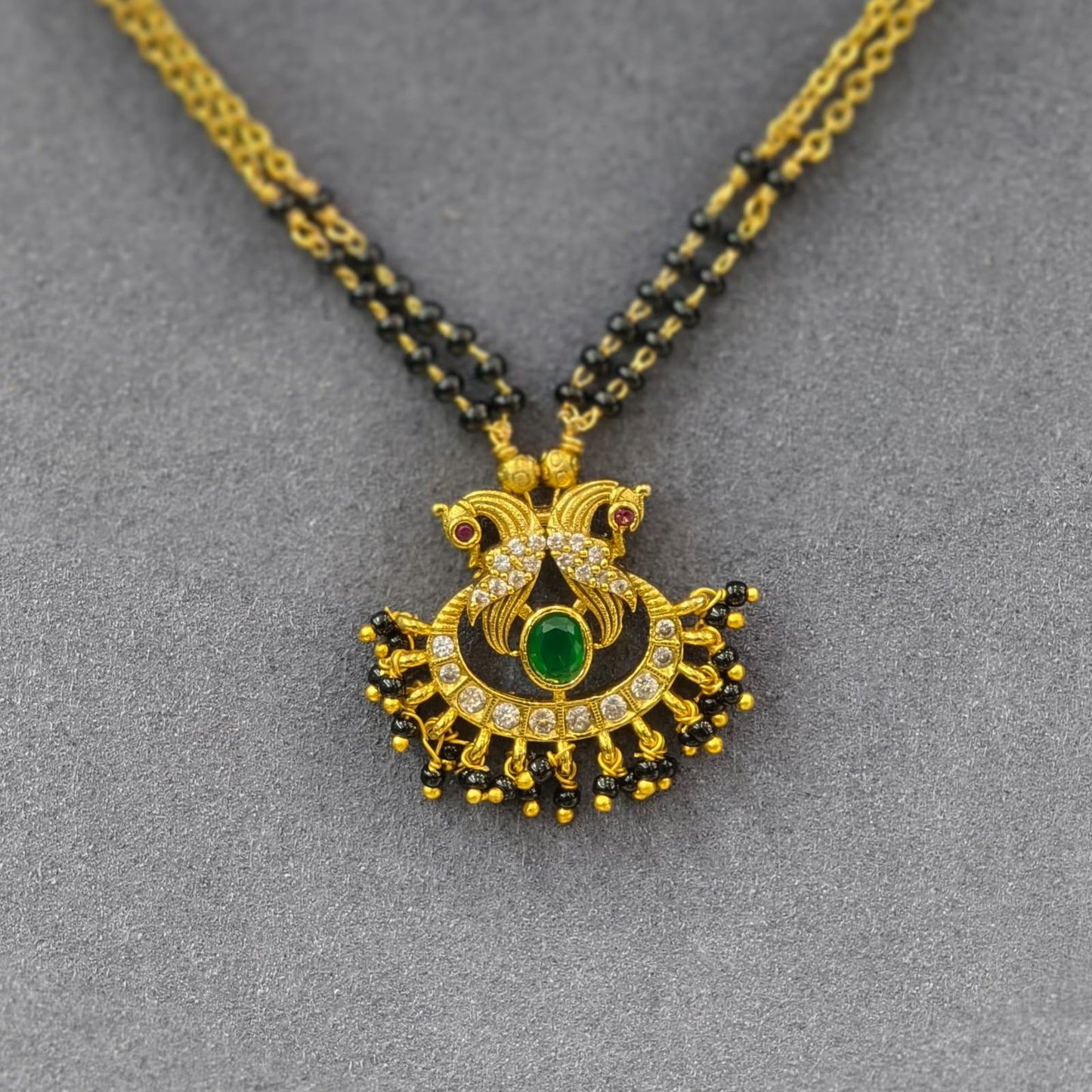Peacock pendant with 2 lines of short black beads